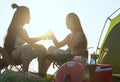 Friends camping eating food concept, Asian couple camping in their tent on the sunny day, Vacation Concept