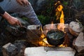 Friends camping eating food concept. A warm fire you to drink and camp in the mountains Royalty Free Stock Photo