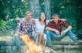 Friends camping in forest. Company having hike picnic nature background. Friends enjoy weekend barbecue in forest Royalty Free Stock Photo