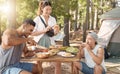 Friends, camping and lunch with young people in the forest for travel, adventure or to explore nature. Food, hiking and Royalty Free Stock Photo