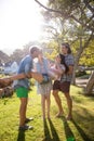 Friends carrying woman in park