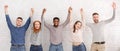 Friends celebrating succeess with raised hands over white wall Royalty Free Stock Photo