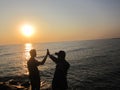 with friends celebrating the success of our trip on the edge of the port of, with a sea as a backdrop with a view of the sunset