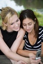 Friends on Cell Phone together (Beautiful Young Blonde and Brunette Girls)