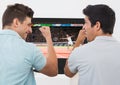 Friends cheering while watching tennis match on television