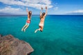 Friends cliff jumping into the ocean Royalty Free Stock Photo