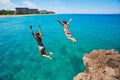 Friends cliff jumping into the ocean Royalty Free Stock Photo