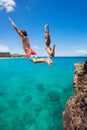 Friends cliff jumping into the ocean Royalty Free Stock Photo