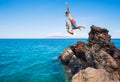 Friends cliff jumping into the ocean Royalty Free Stock Photo