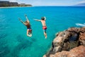 Friends cliff jumping into the ocean Royalty Free Stock Photo