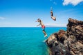 Friends cliff jumping into the ocean Royalty Free Stock Photo