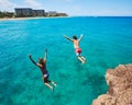 Friends cliff jumping into the ocean Royalty Free Stock Photo