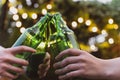 Friends clink on bottles of beer. Outdoor Party with alcohol. Fun and celebration. Birthday Toast