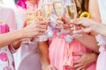 Friends clinking glasses on baby shower party