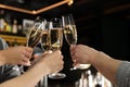 Friends clinking with glasses of champagne in bar Royalty Free Stock Photo