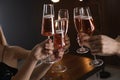 Friends clinking glasses with champagne on blurred background Royalty Free Stock Photo