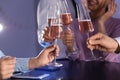 Friends clinking glasses of champagne at table in restaurant Royalty Free Stock Photo