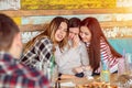 Friends comforting and consoling crying young woman trying to make her laugh, friendship concept Royalty Free Stock Photo