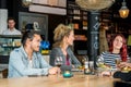 Friends Conversing While Having Food At Restaurant