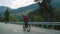 Friends cycling forest road on sport bikes. Carefree travelers enjoy mountains.