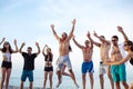 Friends dance on beach under sunset sunlight, having fun, happy, enjoy Royalty Free Stock Photo