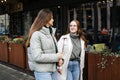 Friends digital detox. Two friends enjoy a face-to-face conversation on city sidewalk, digital detox by engaging in