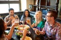 Friends dining and drinking beer at restaurant