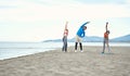 Friends doing fitness with the music on the beach Royalty Free Stock Photo