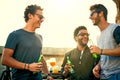 Friends dont let friends have fun alone. a group of young friends hanging out and having drinks together outdoors. Royalty Free Stock Photo