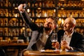 friends drinking beer and taking selfie with smartphone in bar or pub. male friendship - happy. Royalty Free Stock Photo