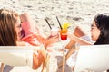 Friends drinking cocktails in beach bar Royalty Free Stock Photo