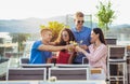 Friends drinking cocktails outdoor on a penthouse balcony Royalty Free Stock Photo