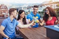 Friends drinking cocktails outdoor on a penthouse balcony Royalty Free Stock Photo