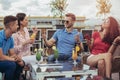 Friends drinking cocktails outdoor on a penthouse balcony Royalty Free Stock Photo