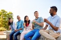 Friends drinking coffee and juice talking in city Royalty Free Stock Photo