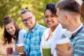 Friends drinking coffee and juice talking in park Royalty Free Stock Photo
