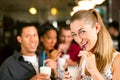 Friends drinking milkshakes in a bar