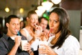 Friends drinking milkshakes in a bar