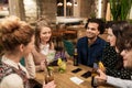 Friends with drinks, money and bill at bar Royalty Free Stock Photo