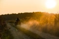 Friends driving an all-terrain vehicle over a dirt road