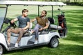 Friends driving golf car
