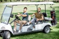 Friends driving golf car