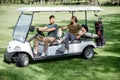 Friends driving golf car Royalty Free Stock Photo