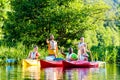 Friends driving with kayak on river