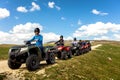 Friends driving off-road with quad bike or ATV and UTV vehicles Royalty Free Stock Photo