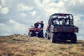 Friends driving off-road with quad bike or ATV and UTV vehicles