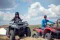 Friends driving off-road with quad bike or ATV and UTV vehicles