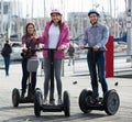 Friends driving segways along sea front