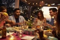 Friends eat and talk at a dinner party on a patio, close up Royalty Free Stock Photo