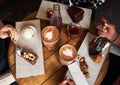 Friends eating desserts and drinking coffee together in a cafe Royalty Free Stock Photo